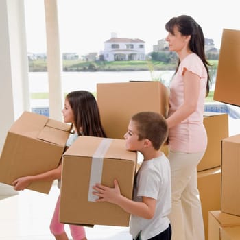 Side profile of a family carrying cardboard boxes
