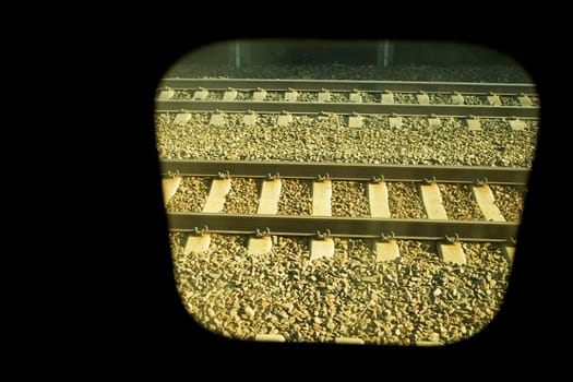 Railroad track viewed through a train window
