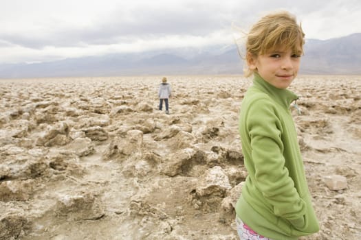 Portrait of a girl standing in a desert