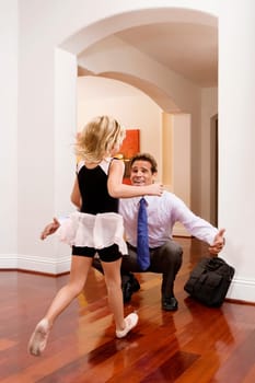 Businessman receiving a warm welcome from his daughter