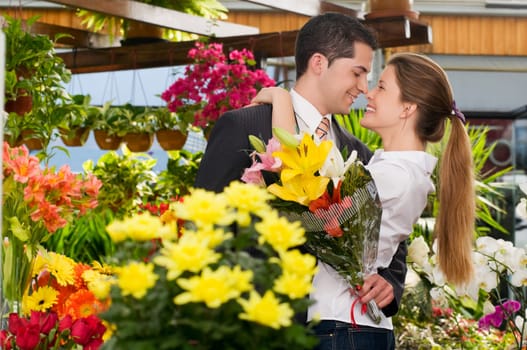 Couple romancing at a flower shop