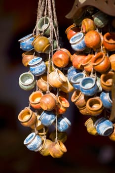Close_up of teacups hanging at a market stall