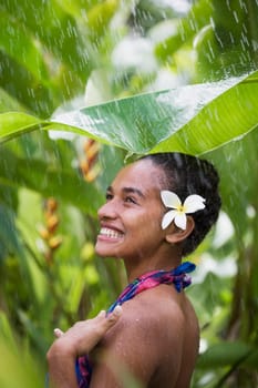 Close_up of a teenage girl enjoying rain shower