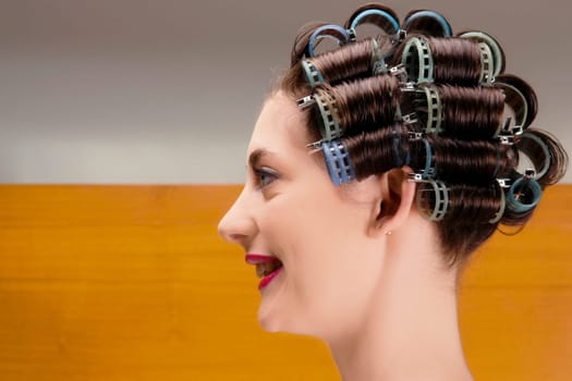 Close_up of a young woman wearing hair rollers