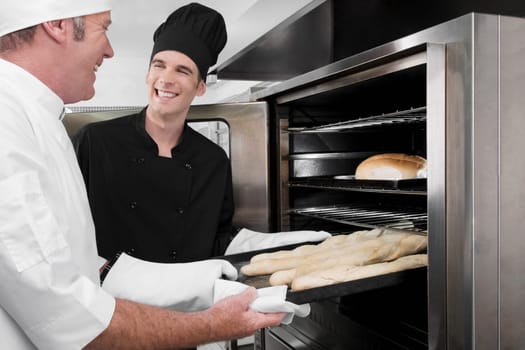 Two chefs preparing food in the kitchen