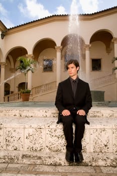 Businessman sitting near a fountain, Biltmore Hotel, Coral Gables, Florida, USA