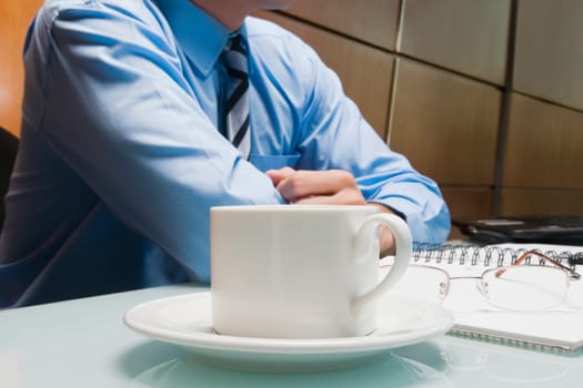 Mid section view of a businessman sitting in an office