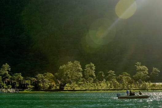 Tourists sitting on a boat in the sea, Tahiti, French Polynesia