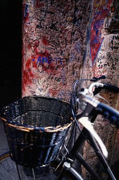 Close_up of a bicycle leaning against a wall