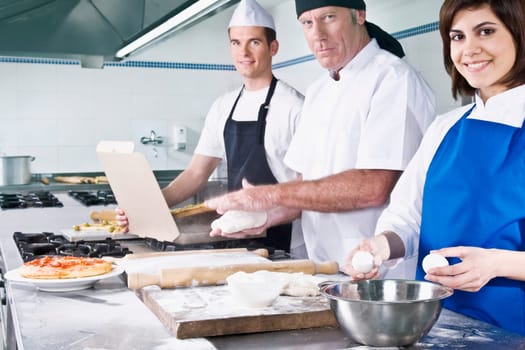 Female and a male chef cooking food in the kitchen