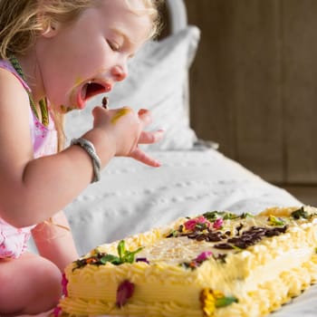 Baby girl eating birthday cake