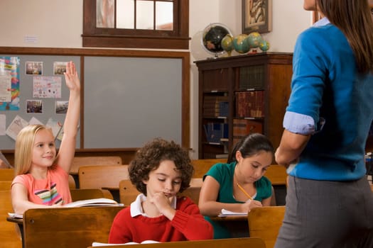 Students studying in a classroom with their teacher