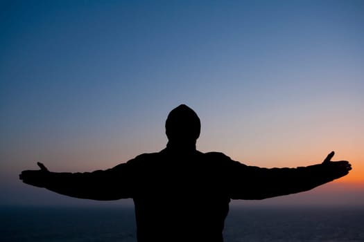 Silhouette of a man standing with his arms outstretched, San Francisco Bay, San Francisco, California, USA