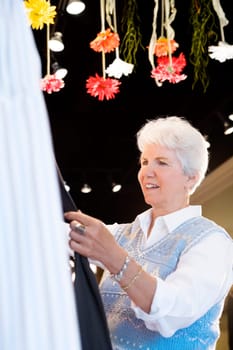 Side profile of a senior woman standing in a store