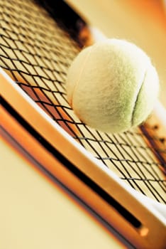 Close_up of a tennis ball and a tennis racket