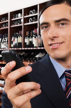 Businessman text messaging on a mobile phone