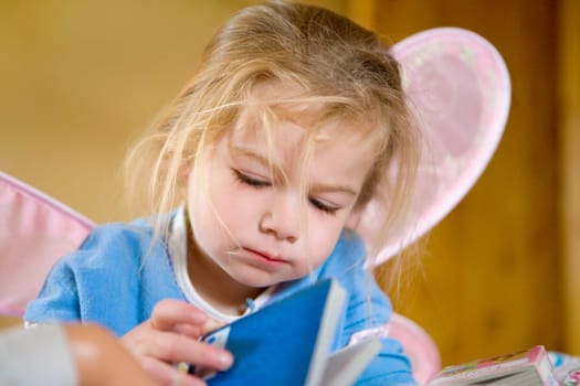 Baby girl holding a book