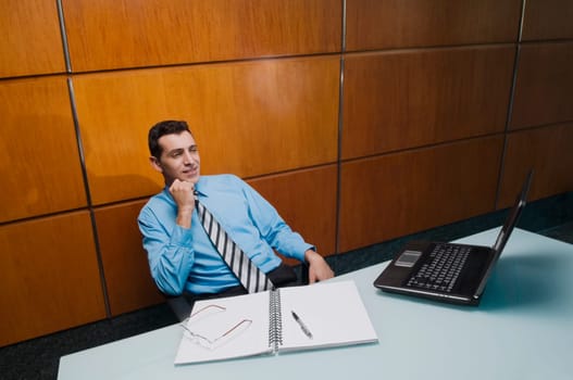 Businessman looking at a laptop in an office