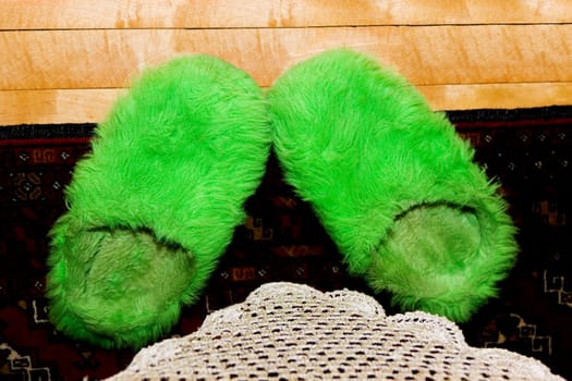 High angle view of fur slippers on a carpet