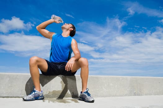 Young man drinking water from a water bottle