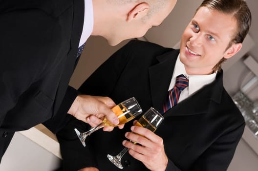 Businessmen toasting with wine in a bar