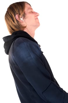 Side profile of a young man listening to music with earbuds and smiling