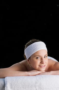Portrait of a young woman lying on a massage table
