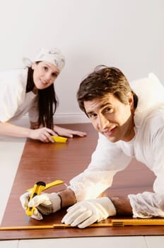 Side profile of a couple marking on a wood panel