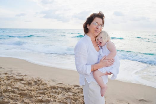 Portrait of a mature woman carrying her granddaughter