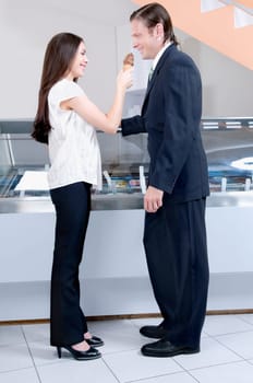 Woman feeding ice cream to a man
