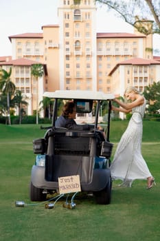 Newlywed couple in a golf cart, Biltmore Golf Course, Biltmore Hotel, Coral Gables, Florida, USA