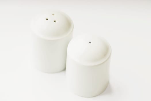 Close_up of a salt shaker and a pepper shaker