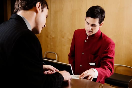 Businessman checking a card at hotel reception