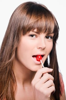 Close_up of a young woman eating a lollipop