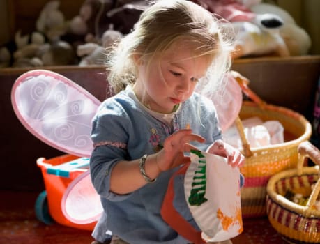 Baby girl painting a paper plate