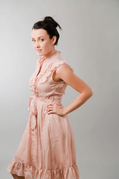 Portrait of a young woman standing with her hand on her hip