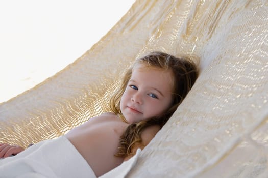 Portrait of a baby girl lying in a hammock