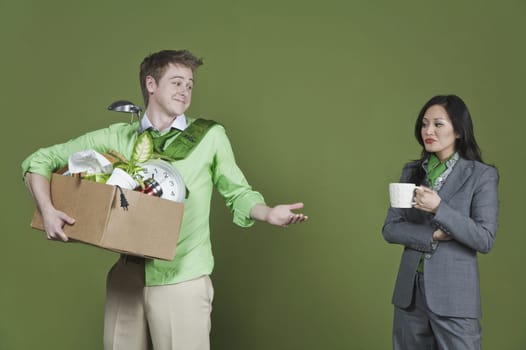 Businessman holding his belongings and a businesswoman holding a cup of coffee