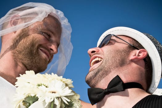 Low angle view of a newlywed gay couple, DuPont Circle, Washington DC, USA