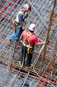 High angle view of two construction workers working at a construction site