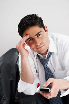 Portrait of a businessman operating a remote control