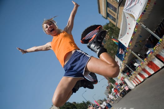 Low angle view of a young woman jumping on the road