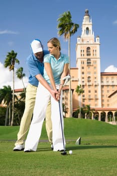 Golf instructor teaching golf to a woman, Biltmore Golf Course, Biltmore Hotel, Coral Gables, Florida, USA