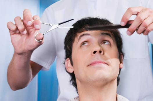 Man receiving a haircut in a salon