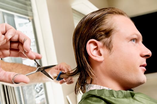 Man receiving a haircut in a salon