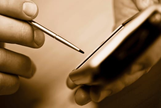 Close_up of a manŽs hand using a personal data assistant