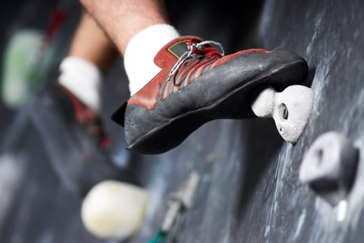 Close_up of a man climbing a wall
