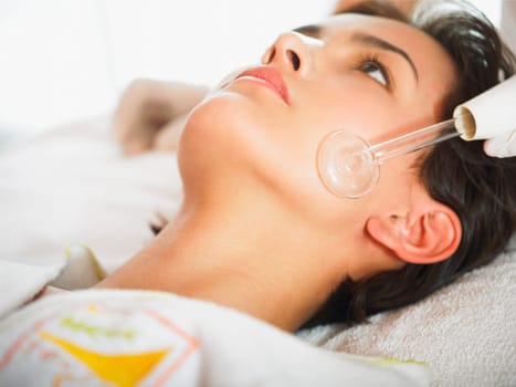 Close_up of a young woman getting a face massage