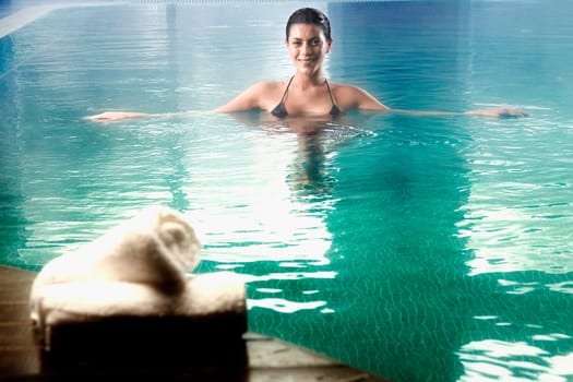 Young woman swimming in a swimming pool