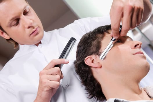 Man receiving a haircut in a salon